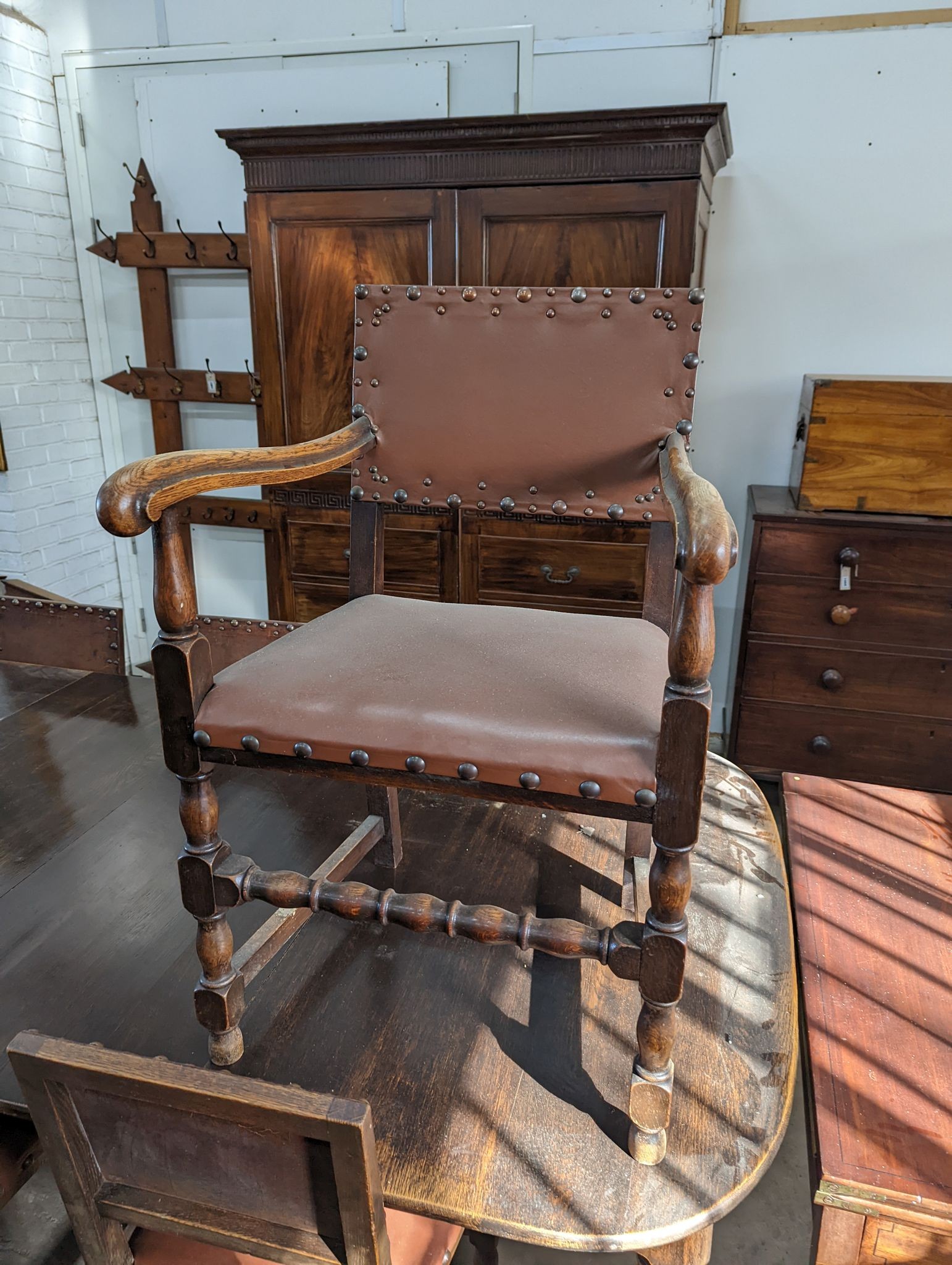 A 1920's oak extending dining table, 238cm extended (two spare leaves), width 120cm, height 74cm together with seven oak dining chairs (one with arms)